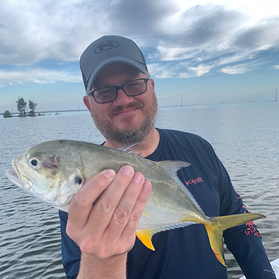 Dustin Goodman holding a jack caught on the water